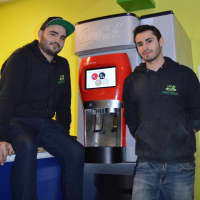 <p>Steve, left, and Daniel Dimenstein with the specialty Coca Cola machine in Mediterranea.</p>