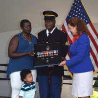 <p>Robert Carpenter, with his wife and grandson, is presented with his military medials by U.S. Rep. Elizabeth Esty.</p>