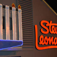 <p>Rabbi Yehoshua Hecht lights the menorah at Stew Leonard&#x27;s in Norwalk Monday.</p>