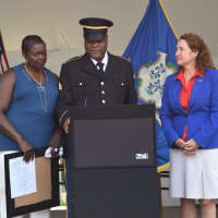 <p>Robert Carpenter, with his wife and U.S. Rep. Elizabeth Esty, speaks at the medal ceremony at the Danbury Green.</p>