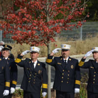 <p>Millwood firefighters give salutes during a flag-raising ceremony on the grounds of the new firehouse.</p>