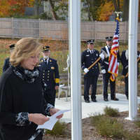 <p>Hala Makowska, chair of the Millwood Board of Fire Commissioners, speaks following a flag-raising ceremony at the new firehouse.</p>