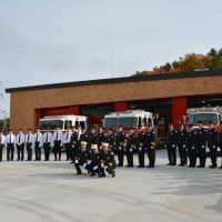 <p>Millwood firefighters pose for photos in front of their new firehouse.</p>