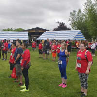<p>Runners/walkers listen to the National Anthem prior to Sunday&#x27;s 5K.</p>
