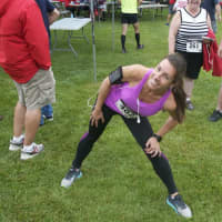 <p>A runner stretches prior to the start of Sunday morning&#x27;s 5K.</p>