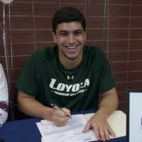 <p>Luca DeCapua, from Fox Lane High, signs with Loyola.</p>