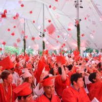 <p>Members of Fox Lane High School&#x27;s Class of 2016 celebrate at commencement by throwing their mortarboards in the air.</p>