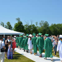<p>Members of Webutuck High School&#x27;s Class of 2016 march to their commencement, which was held under a tent on an athletic field.</p>