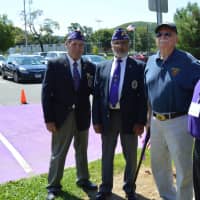 <p>Some of the men posing in front of the newly painted purple parking spot.</p>