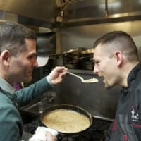 <p>County Executive Marcus Molinaro offers a taste of his creation to Bluestone Bistro Chef and owner Michael Polasek.</p>