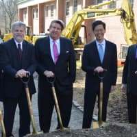 <p>Summit Development President Felix Charney, center, poses for photos with his project team, who have helped him over the years with multiple proposals for the site.</p>