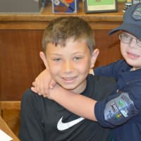<p>Jack hugs his brother, Michael, at Pierrepont School.</p>