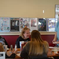 <p>Magician Bryan Lizotte shares a card trick with customers at Magic Cafe in Shelton.</p>