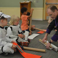 <p>Sensei Morgan Ewing helps young stormtroopers create light sabers at Jedi Academy in Fairfield.</p>