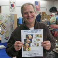 <p>Ridgefield illustator Chris Calle holds some of the covers he designed.</p>