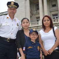 <p>East Rutherford Police Chief Larry Minda with Vanessa Uribe-Garcia and her family.</p>