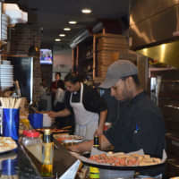 <p>Workers cook up delectable pies at Milano Wine Bar &amp; Pizzeria Tuesday.</p>