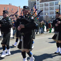 <p>Members of the Fairfield County Police Pipe s&amp; Drums march down Broad Street in Bridgeport.</p>