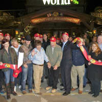 <p>Bridgeport Mayor Bill Finch (right, holding the ribbon) and other dignitaries and officials officially open the new Bass Pro Shop.</p>