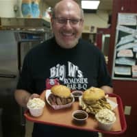 <p>Big W&#x27;s owner Warren Norstein with some of his wildly popular smoked brisket and chicken.</p>