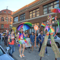 <p>Stilt walker Lady Blaze leads the Pride Walk through downtown Bridgeport.</p>