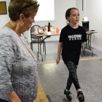<p>Patsy Early McLoughlin, one of the directors of the McLoughlin School of Irish Dance, observes the form of Evelyn McGowan of Glen Rock.</p>