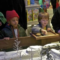 <p>A boy takes control of a toy train at Bass Pro.</p>