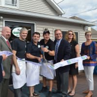 <p>Milanno Ukehaxhaj, fourth from left, and Gaetano Catalano, fourth from right, celebrate their new location in Stratford on Wednesday.</p>