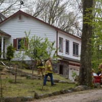 <p>Firefighters at the scene of a house fire in Goldens Bridge. The place damaged a house located in the Colony.</p>