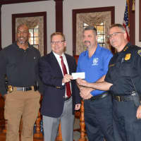 <p>Stratford Mayor John Harkins, second from left, donates $10,000 from his charity golf tournament to Stratford PAL as (left to right) Lt. Curtis Eller, School Resource Officer Alex Voccola and Police Chief Joseph McNeil look on.</p>