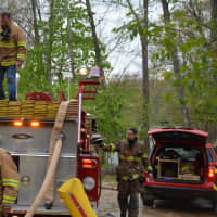 <p>Firefighters at the scene of a house fire in Goldens Bridge. The blaze damaged a house that is located in the Colony.</p>