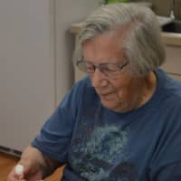 <p>Administrative volunteer Micheline Hodge at work in the kitchen.</p>