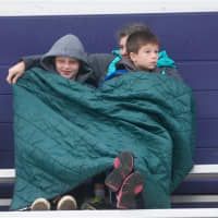 <p>Fans try to stay warm in the bleachers at Wednesday&#x27;s game.</p>