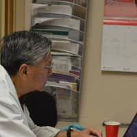 <p>Dr. Henry Lau, a volunteer physician, working at Bergen Volunteer Medical Initiative in Hackensack.</p>
