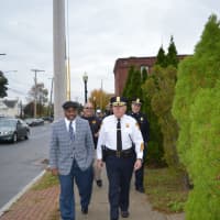 <p>Harold Dimbo, left, of Project Longevity and Bridgeport Police Chief A.J. Perez join police officers in a walk around the city&#x27;s East End.</p>
