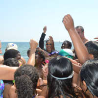 <p>Kids in the Horizons program cheer after a swimming relay at Seaside Park.</p>