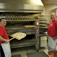 <p>It&#x27;s always busy around the oven at Danny&#x27;s Pizza. Owner Danny Morton is on the right.</p>