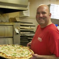 <p>Danny&#x27;s owner Danny Morton, with one of his hugely popular pizzas.</p>