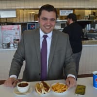 <p>Michael Potoczak of Totowa enjoying two Rutt&#x27;s Hut rippers –with chili and relish – and cheese fries on his lunch break.</p>