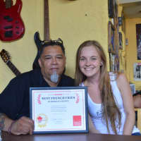 <p>Rony Alvarado, left, owner, and Lauren Kelly, waitress, at Rony&#x27;s Rockin&#x27; Grill in Bergenfield.</p>