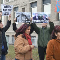 <p>Make the Road organizers Julio Lopez, left, and Barbara Lopez, center, help rally the demonstrators outside Bridgeport City Hall.</p>