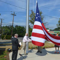 <p>Bottle King owner Kenneth Friedman and members of the American Legion and VFW raising the flag</p>