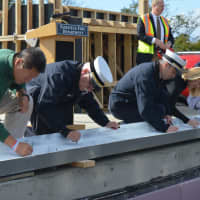 <p>Fairfield dignitaries sign a steel beam before it&#x27;s placed atop the new Fairfield Regional Fire Training School.</p>