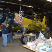<p>Richie Jersey left and Mark Corvino work on the Corsair that will be one of the points of pride in the Curtiss Hangar annex of the Connecticut Air and Space Center.</p>