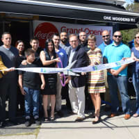 <p>Stratford Mayor John Harkins and Mayra Cabrera, center, cut the ribbon on Cibus, Cabrera&#x27;s new Latin fusion restaurant.</p>