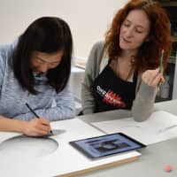 <p>Lena Christinger of Ridgewood draws her first sphere as Julie Rogers offers guidance.</p>