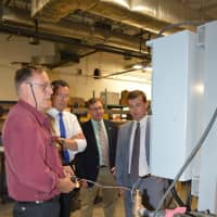 <p>Jeff Jarosz, left, an engineer at Phillips Fuel Systems, explains a system to Gov. Dannel Malloy, Bridgeport City Council member Scott Burns and state Rep. Steve Stafstrom.</p>