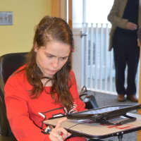 <p>Fairfield University sophomore Meg Moore answers reporters&#x27; questions using a communications device on her  new wheelchair.</p>