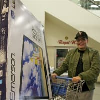 <p>This man is all smiles after finding his big-screen TV on Black Friday.</p>
