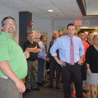 <p>Unit Director Jason Macchia, left, leads U.S. Sen. Chris Murphy, center, and others on a tour of the Smilow-Burroughs Clubhouse in Bridgeport.</p>